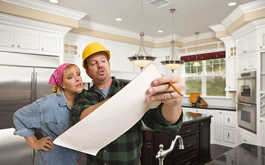 Image showing Contractor Discussing Plans with Woman Inside Custom Kitchen Int