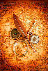 Image showing Vintage magnifying glass lies on an ancient world map