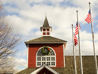 Image showing red white and blue flags on a pole with american architecture