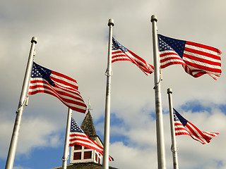 Image showing red white and blue flags on a pole with american architecture