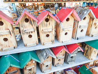 Image showing array of handmade birdhouses for sale