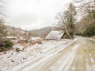 Image showing winter shack and mountain  farm road