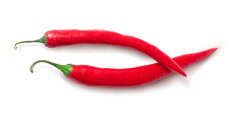 Image showing Two red chili peppers crossed