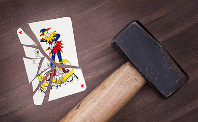 Image showing Hammer with a broken card, joker