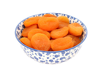 Image showing Dried apricots in a blue and white china bowl