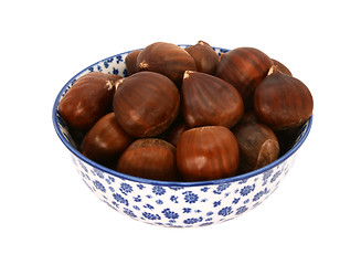 Image showing Sweet chestnuts in shells, in a blue and white china bowl