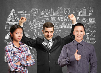 Image showing Asian team and businessman with hands up