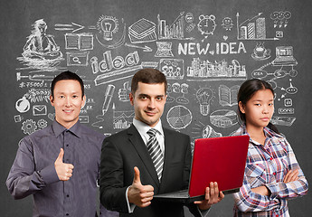 Image showing Asian team and male in suit with laptop in his hands