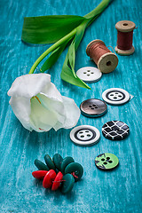 Image showing one white tulip and buttons with threads