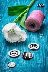 Image showing one white tulip and buttons with threads