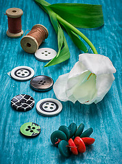 Image showing one white tulip and buttons with threads