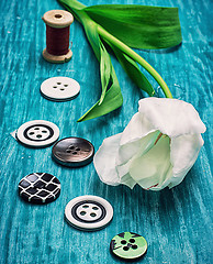 Image showing one white tulip and buttons with threads