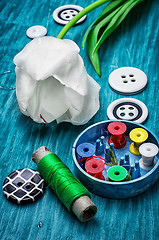 Image showing one white tulip and buttons with threads