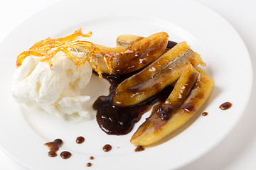 Image showing Fried bananas, sauce and ice cream