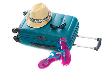 Image showing Blue plastic bag, straw hat, sunglasses and beach shales