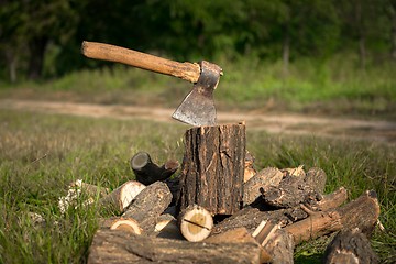 Image showing Firewood and old axe