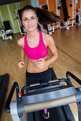 Image showing woman exercising on treadmill in gym