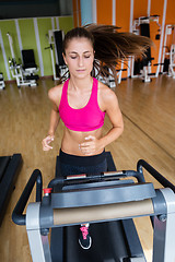 Image showing woman exercising on treadmill in gym