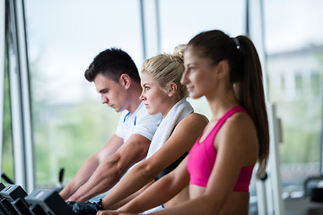 Image showing friends  exercising on a treadmill at the bright modern gym