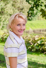Image showing Portrait of a middle-aged woman in a park on a sunny day