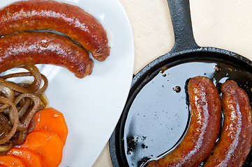 Image showing beef sausages cooked on iron skillet 