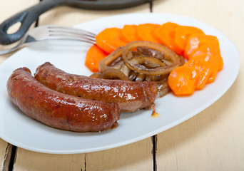 Image showing beef sausages cooked on iron skillet 