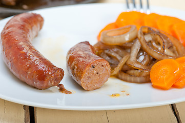 Image showing beef sausages cooked on iron skillet 