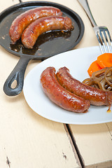 Image showing beef sausages cooked on iron skillet 