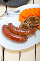 Image showing beef sausages cooked on iron skillet 