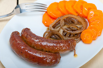 Image showing beef sausages cooked on iron skillet 