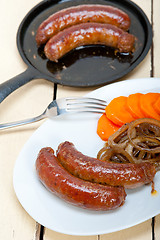 Image showing beef sausages cooked on iron skillet 