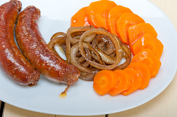 Image showing beef sausages cooked on iron skillet 