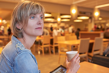 Image showing Woman sitting in the cafe