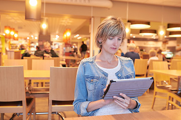 Image showing Woman sitting in the cafe using digital tablet