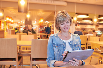 Image showing Woman sitting in the cafe using digital tablet