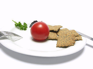 Image showing Tomato with hand make crisp bread on a white plate