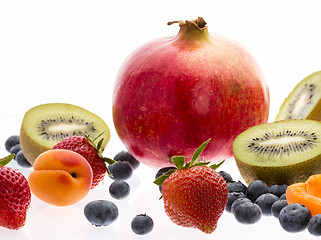 Image showing Halved Kiwi Fruits And Berries On White Background