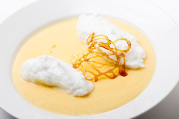 Image showing Poached meringe on custard