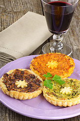 Image showing Mini quiches and red wine