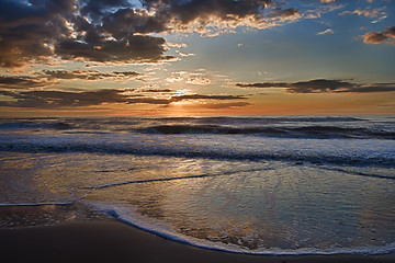 Image showing Sunset over sea with clouds