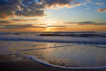 Image showing Sunset over sea with clouds