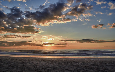 Image showing Sunset over sea with clouds