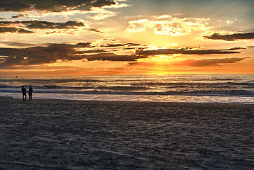 Image showing Happy couple walking on the beach at sunrise for holiday time