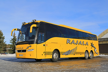 Image showing Yellow Volvo Coach Bus Parked in Winter