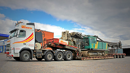 Image showing Volvo FH16 Truck Hauls Pile Driver on Double Drop Deck Trailer