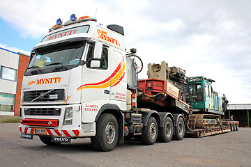 Image showing Volvo FH16 Truck Hauls Pile Driver on Double Drop Deck Trailer