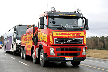 Image showing Volvo FH13 Heavy Duty Tow Truck Tows a Bus