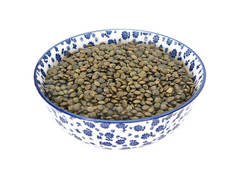 Image showing Marbled dark green lentils in a blue and white china bowl