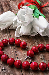 Image showing tulips and womens coral beads
