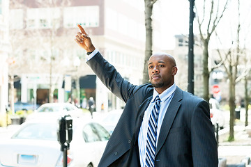 Image showing Man Hailing a Taxi Cab